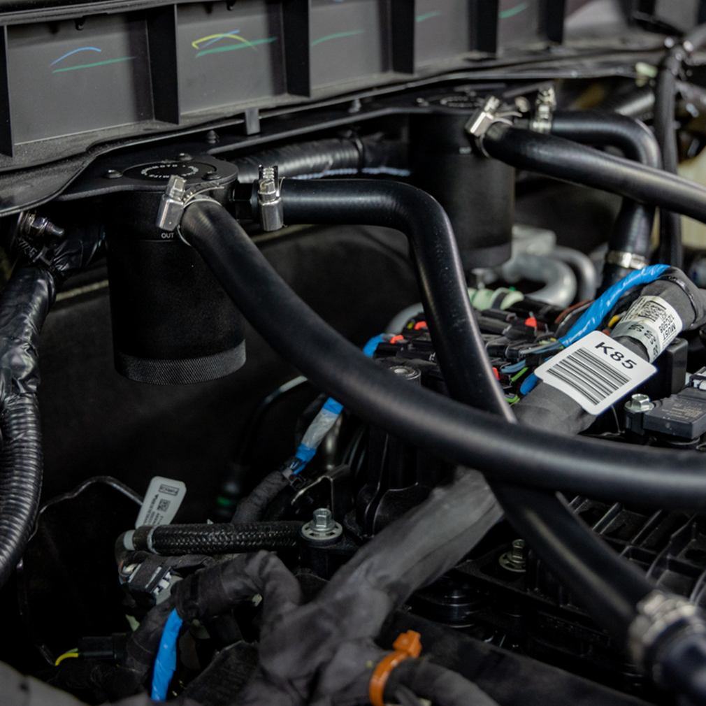 Sturdy 2.5mm-thick steel bracket securing Mishimoto dual catch cans on Ford Bronco 2.7L EcoBoost engine