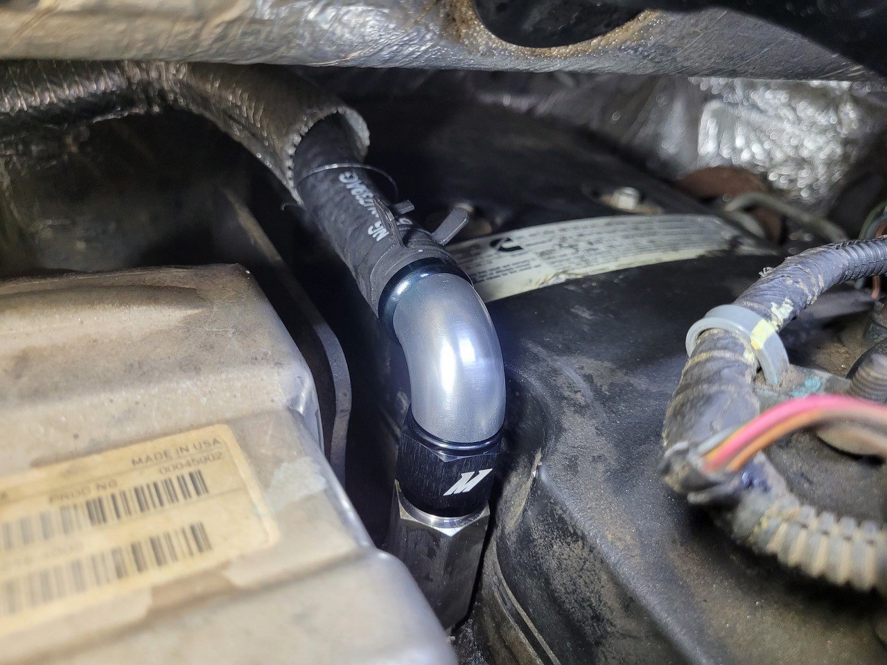 1/2-14 NPT threaded inlet on Mishimoto stainless steel heater hose fitting for RAM 6.7L Cummins