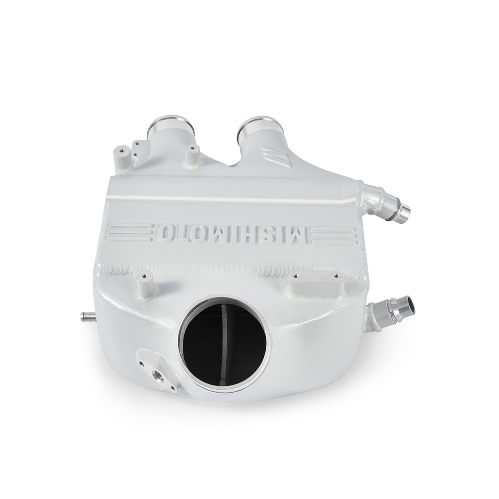 Close-up of Mishimoto intercooler end tank showing internal air diverters and TIG-welded construction