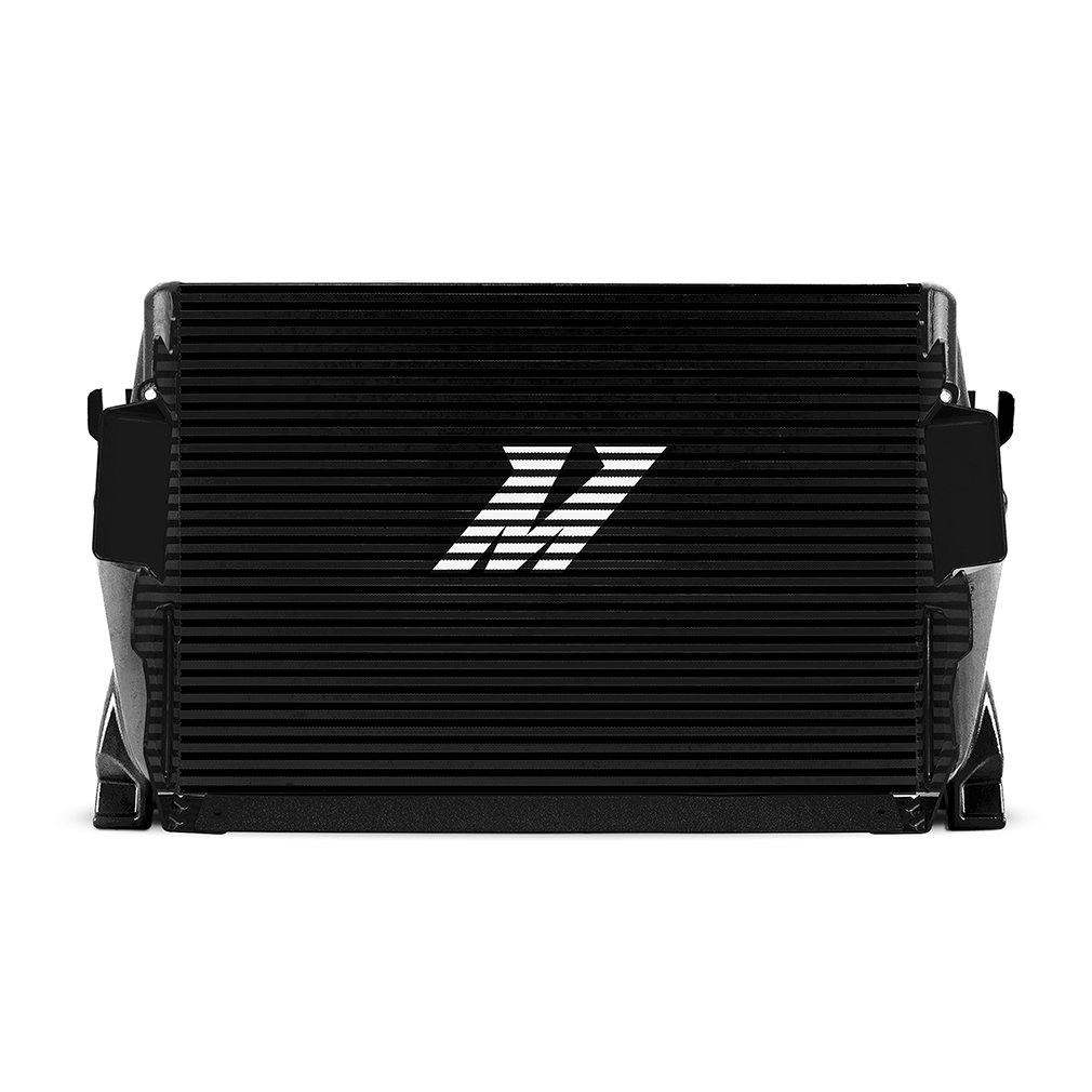 Mishimoto Stealth Black intercooler installed showing powder-coated hot-side and cold-side aluminum pipes