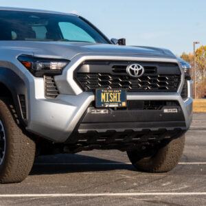 Mishimoto MMLP-TAC-24 license plate relocation kit installed on a 2024+ Toyota Tacoma front bumper