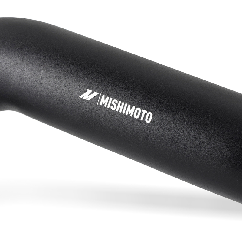Mishimoto intercooler pipe kit components laid out including pipes, boots, and clamps