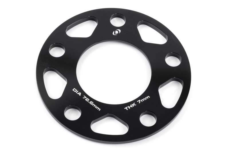 Close-up of Dinan D210-2037 spacers showing 72.6mm center bore